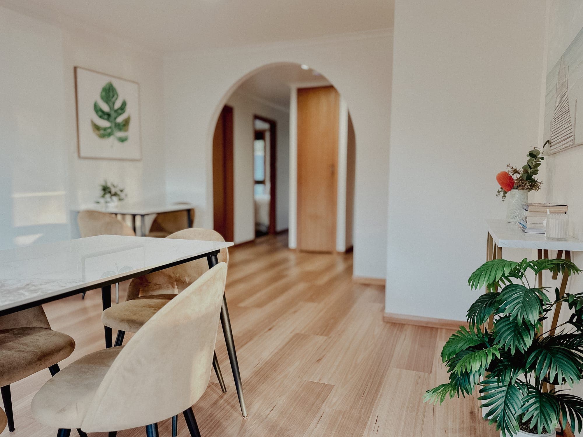 LunaStay — dining space beneath the archway, hallway beyond