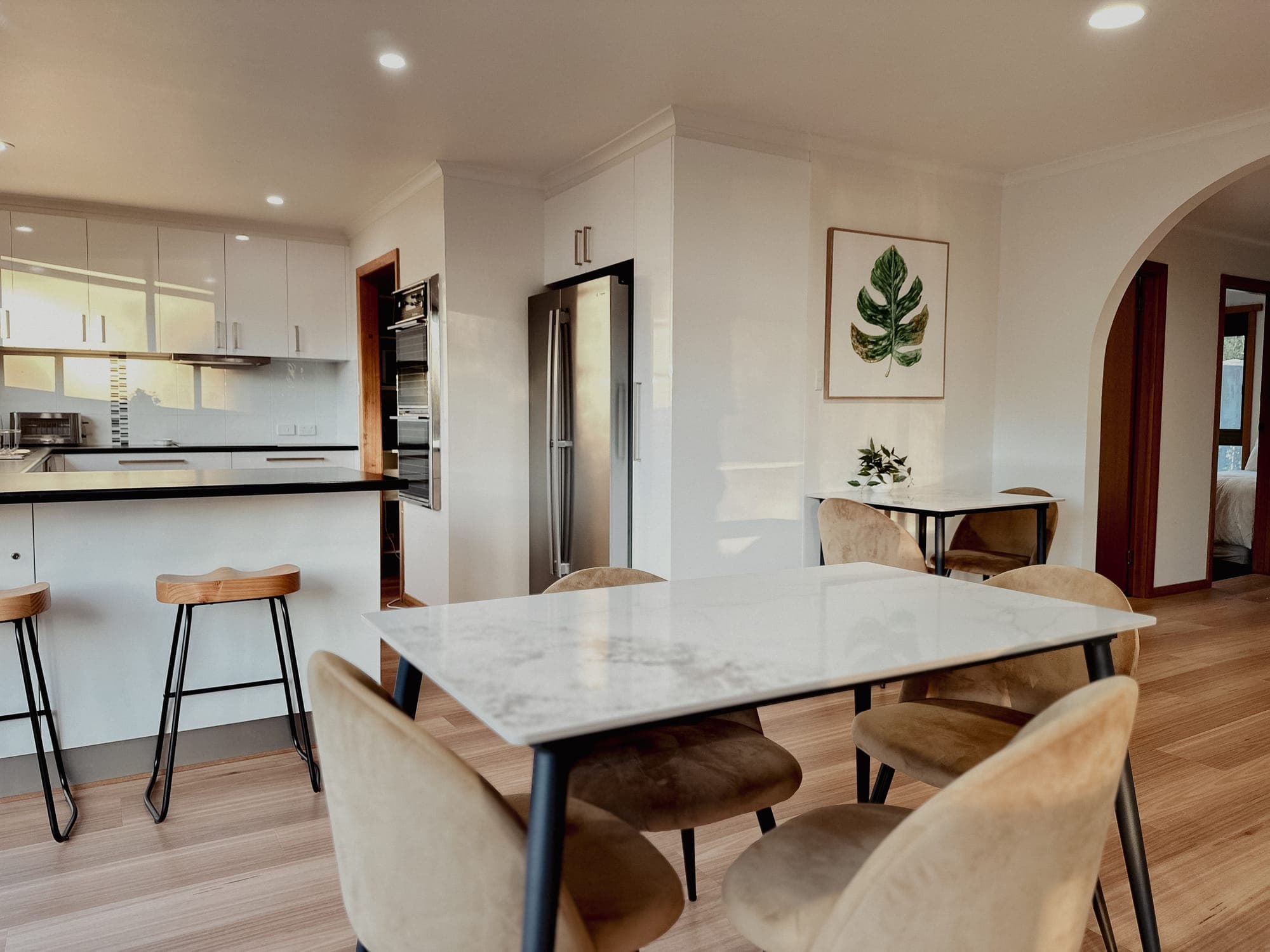 LunaStay — marble dining table beside the kitchen and breakfast bar